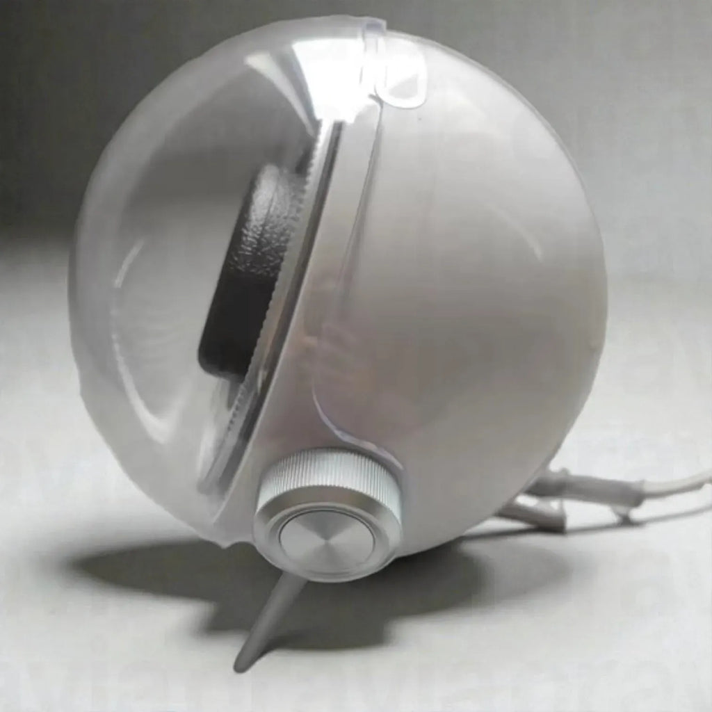 White spherical device with a black interior on a gray background