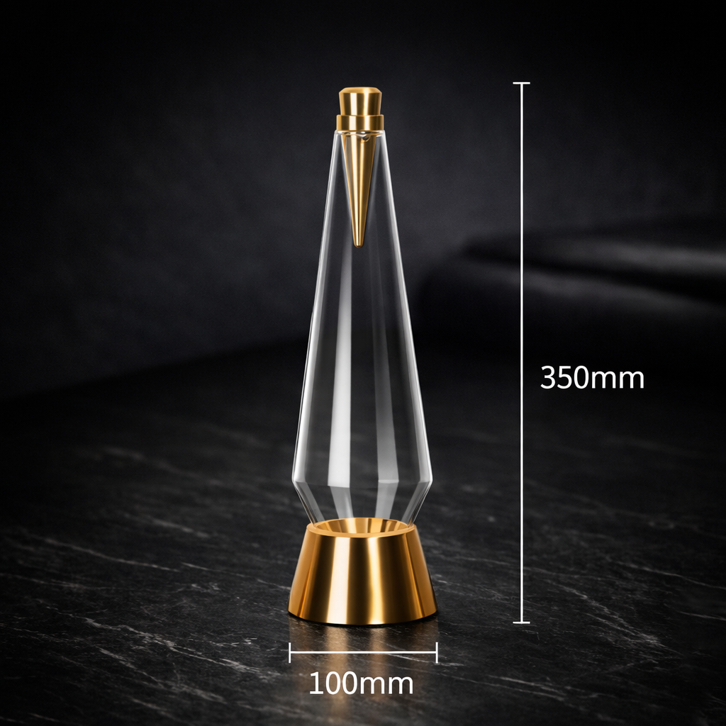 Gold and clear glass decorative item with measurements on a dark surface