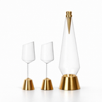 Set of three glass and brass table lamps on a white background