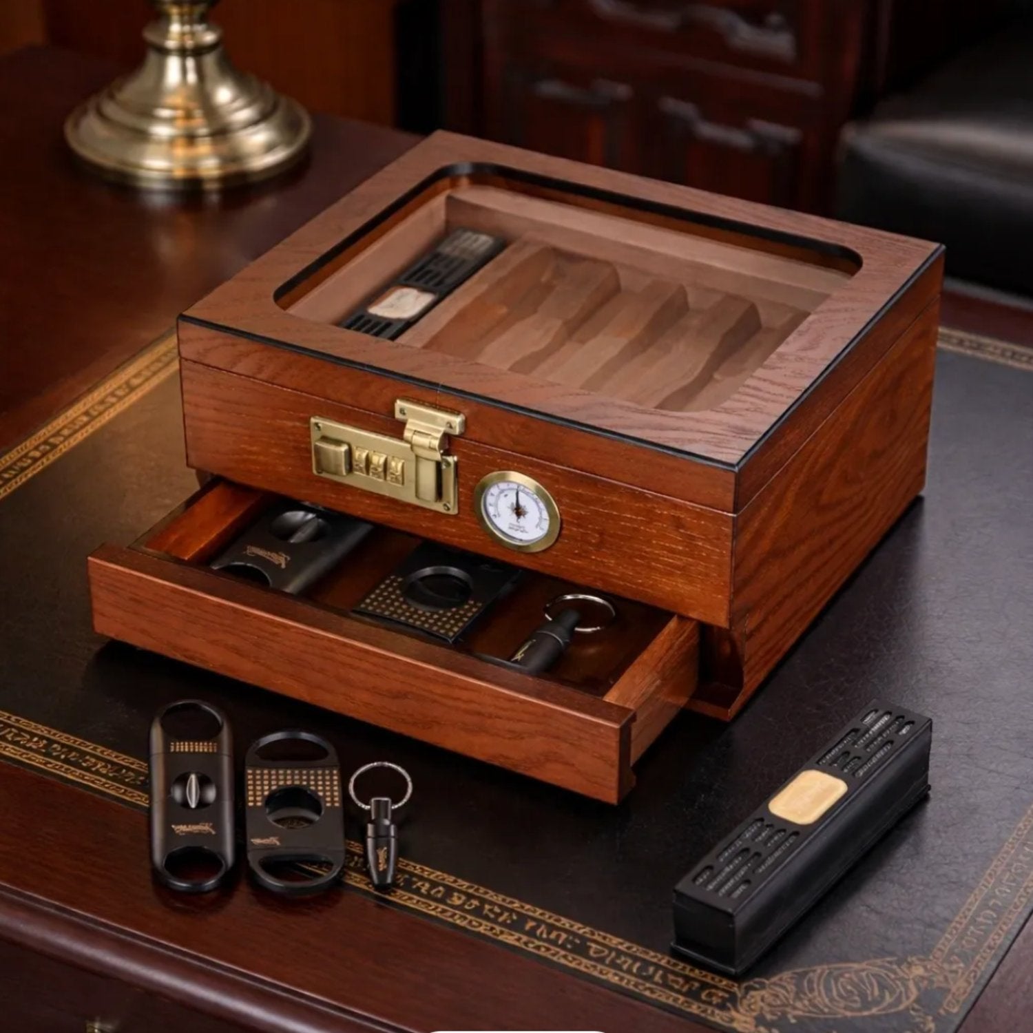 Wooden humidor with accessories on a wooden surface