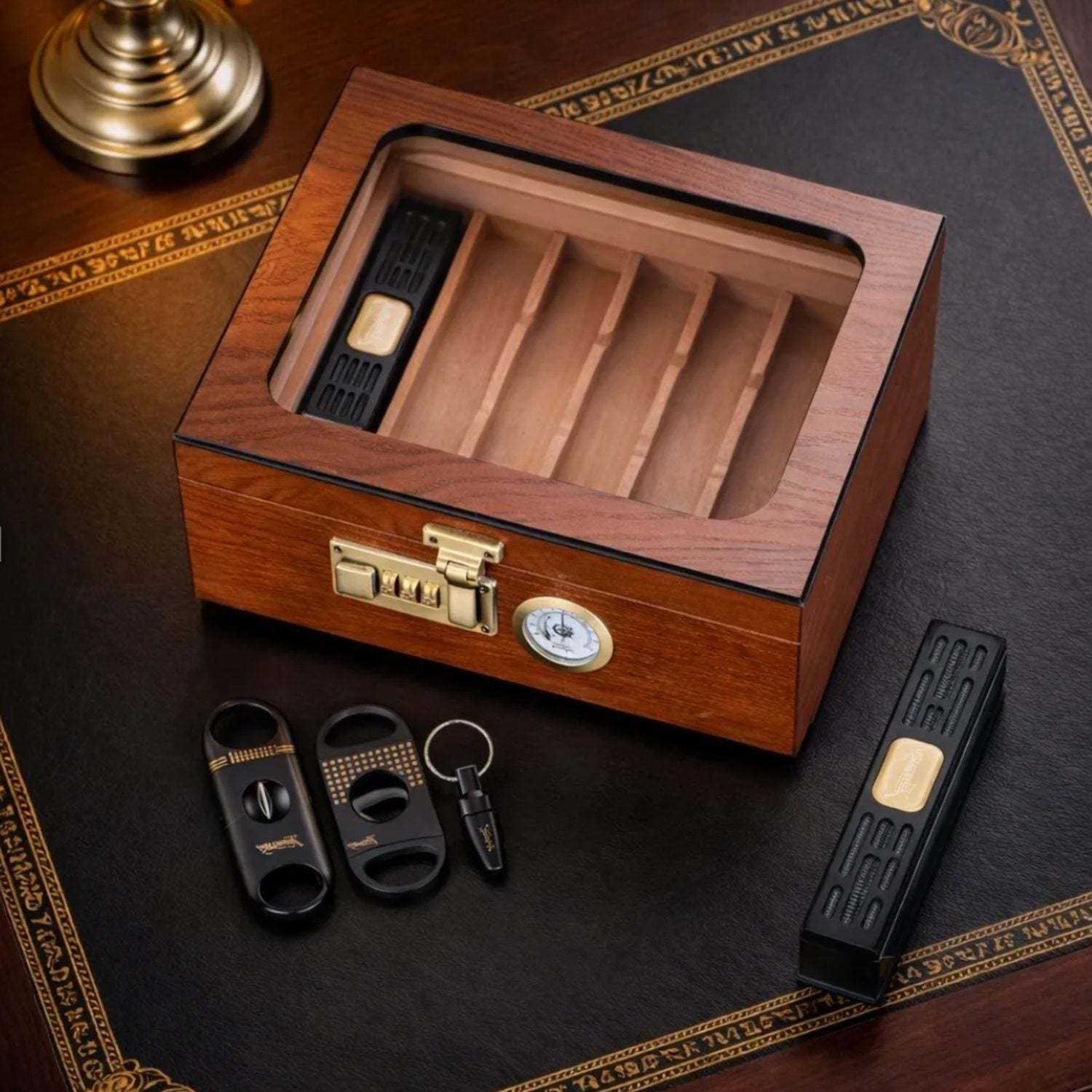 Wooden humidor with smoking accessories on a dark surface