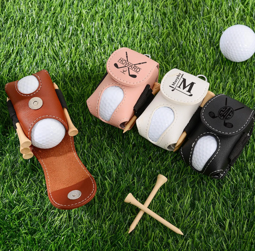Four golf ball holders with golf balls on a grass background