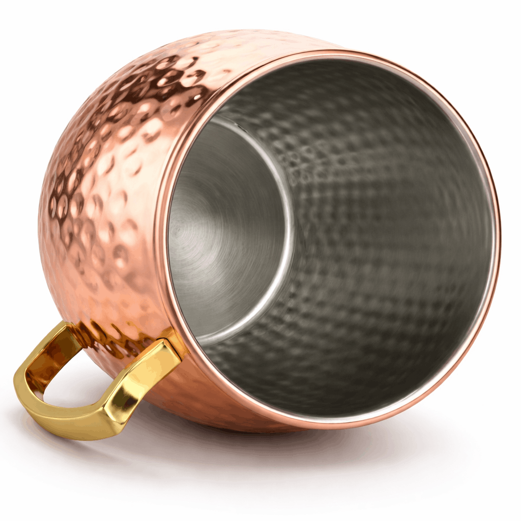 Copper mug with a gold handle on a white background