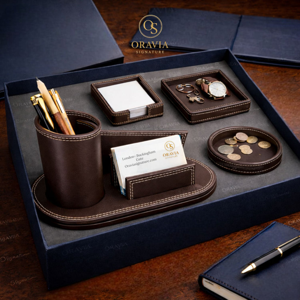 Oravia leather desk set with pen holder, business card holder, and coin tray on a wooden surface.