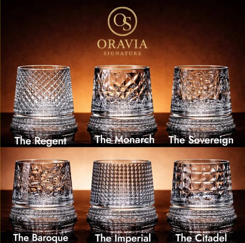 Collection of crystal glasses with 'Oravia' branding on a dark background