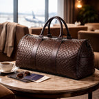 Brown woven duffel bag on a table with sunglasses and a passport in a room with a cityscape view.