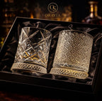 Two crystal glasses with intricate designs in a black box, branded 'Oravia'.