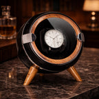 Watch winder with a watch inside on a marble surface