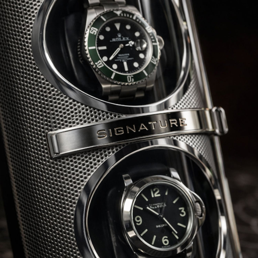 watch winder
Two watches in a metallic display case with 'Signature' branding.