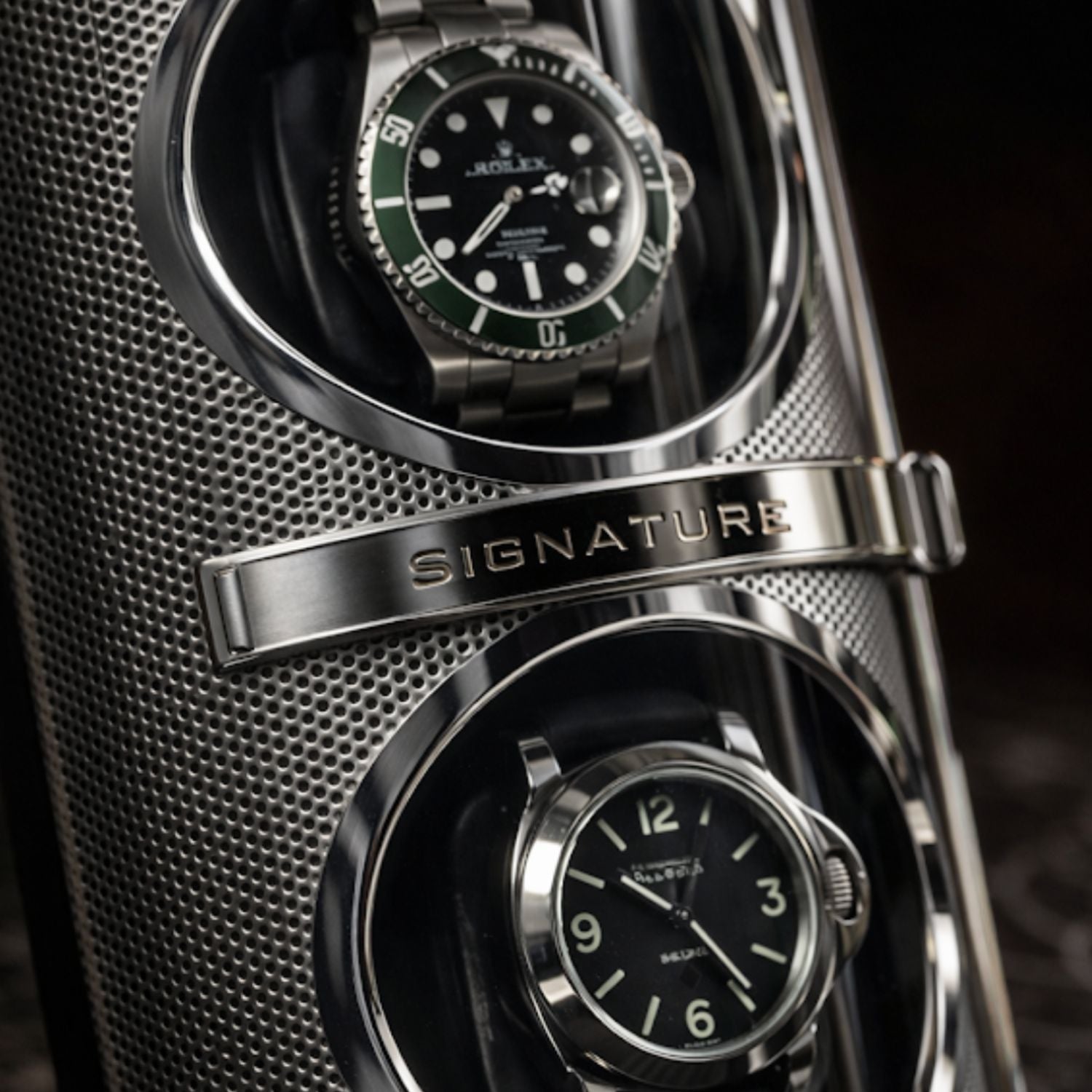 watch winder
Two watches in a metallic display case with 'Signature' branding.
