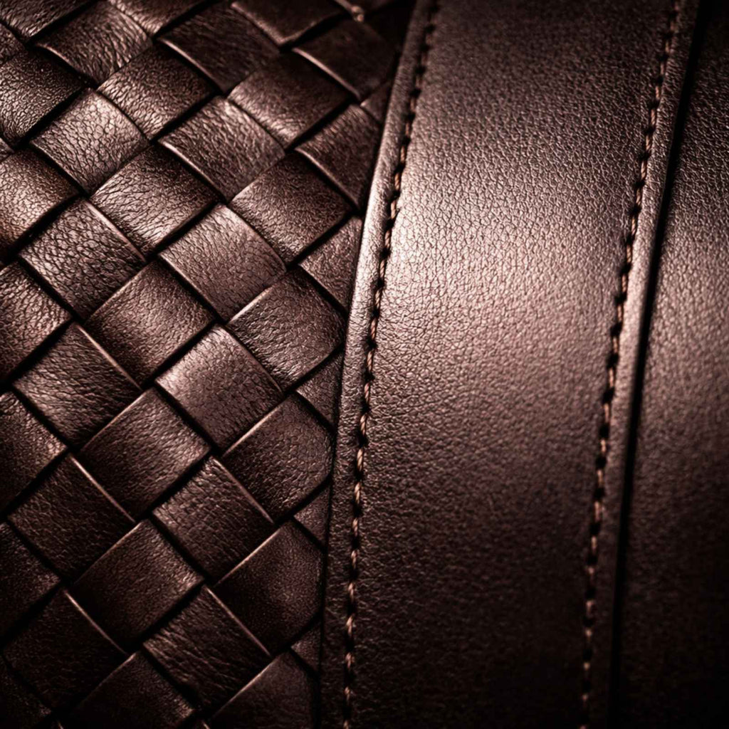 Close-up of brown leather with woven pattern and stitching