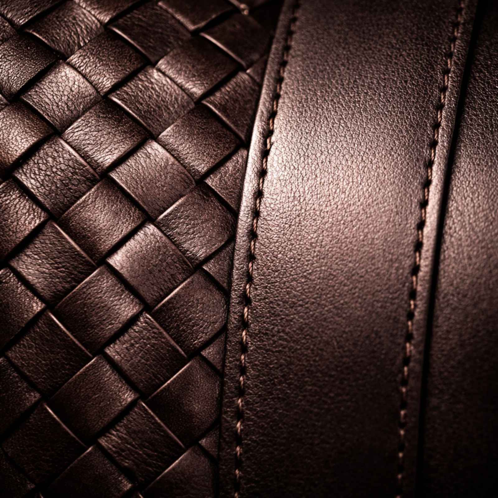 Close-up of brown leather with woven pattern and stitching