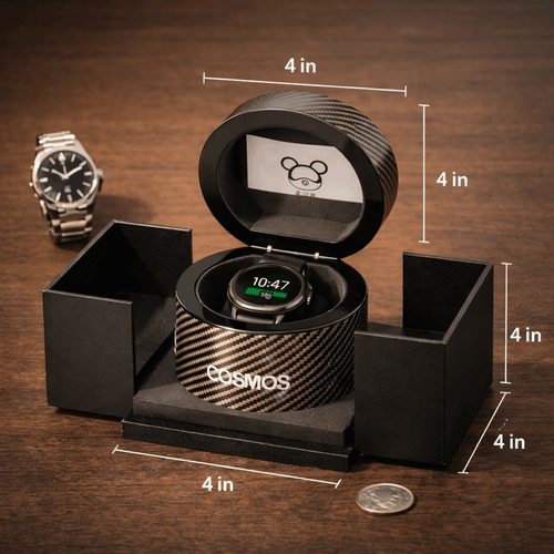Black watch box with a smartwatch inside, labeled 'Cosmos', on a wooden surface with measurement markings.