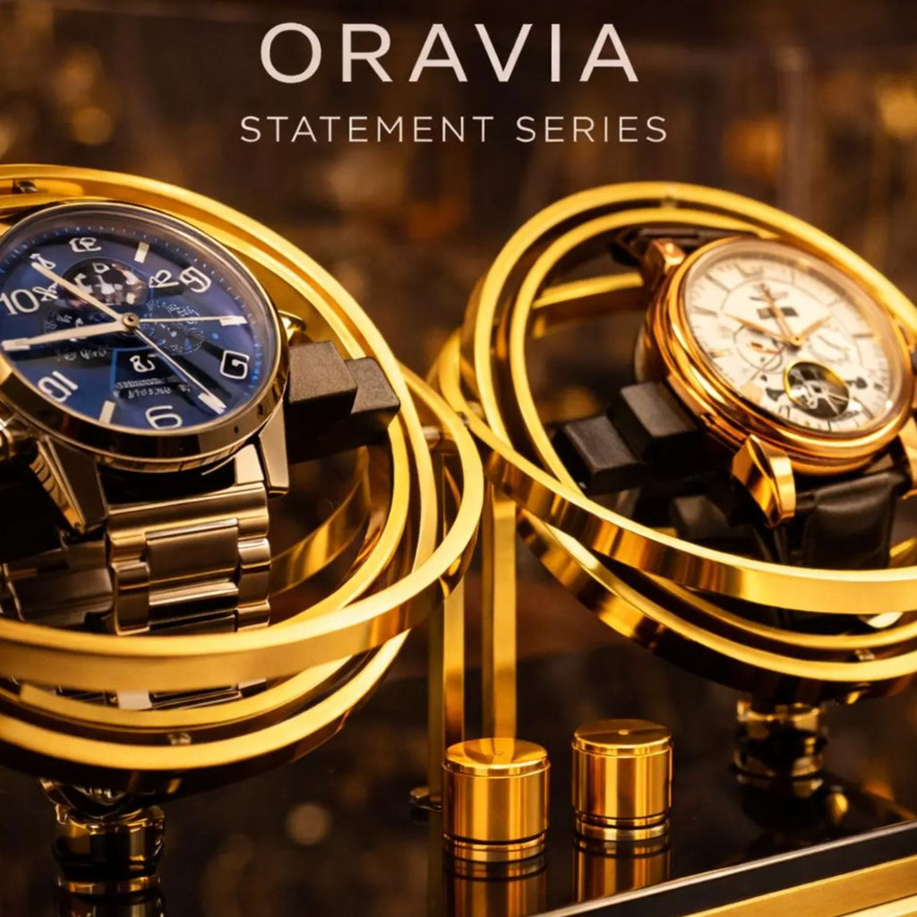 Two gold watches on a decorative stand with 'ORAVIA' branding.watch winder 